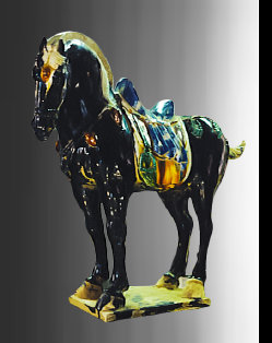 A restored Tang Dynasty funerary horse that is black, and the saddle is glazed in blue, green, and cream colors. The horse is monumental 
in size, and it was in smashed condition before restoration.